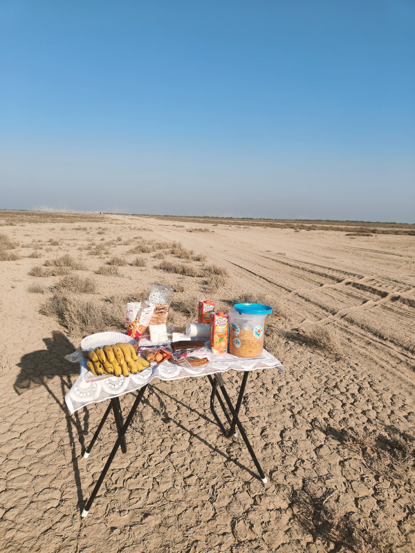 A breakfast table laid out in the middle of the Chaari Desert