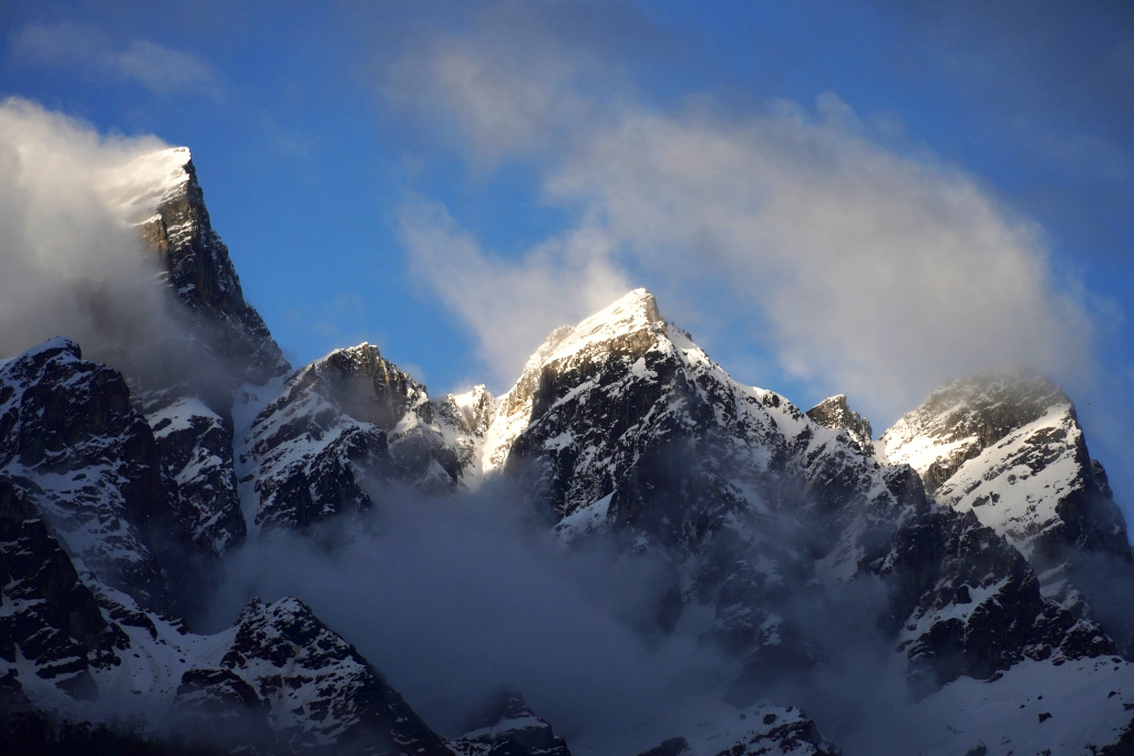 snowcapped mountains covered in clouds